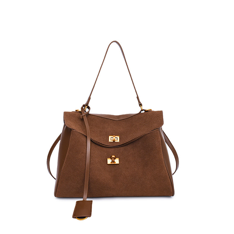 Vintage chamois leather tote bag with adjustable strap and gold hardware, perfect for fall and winter seasons.