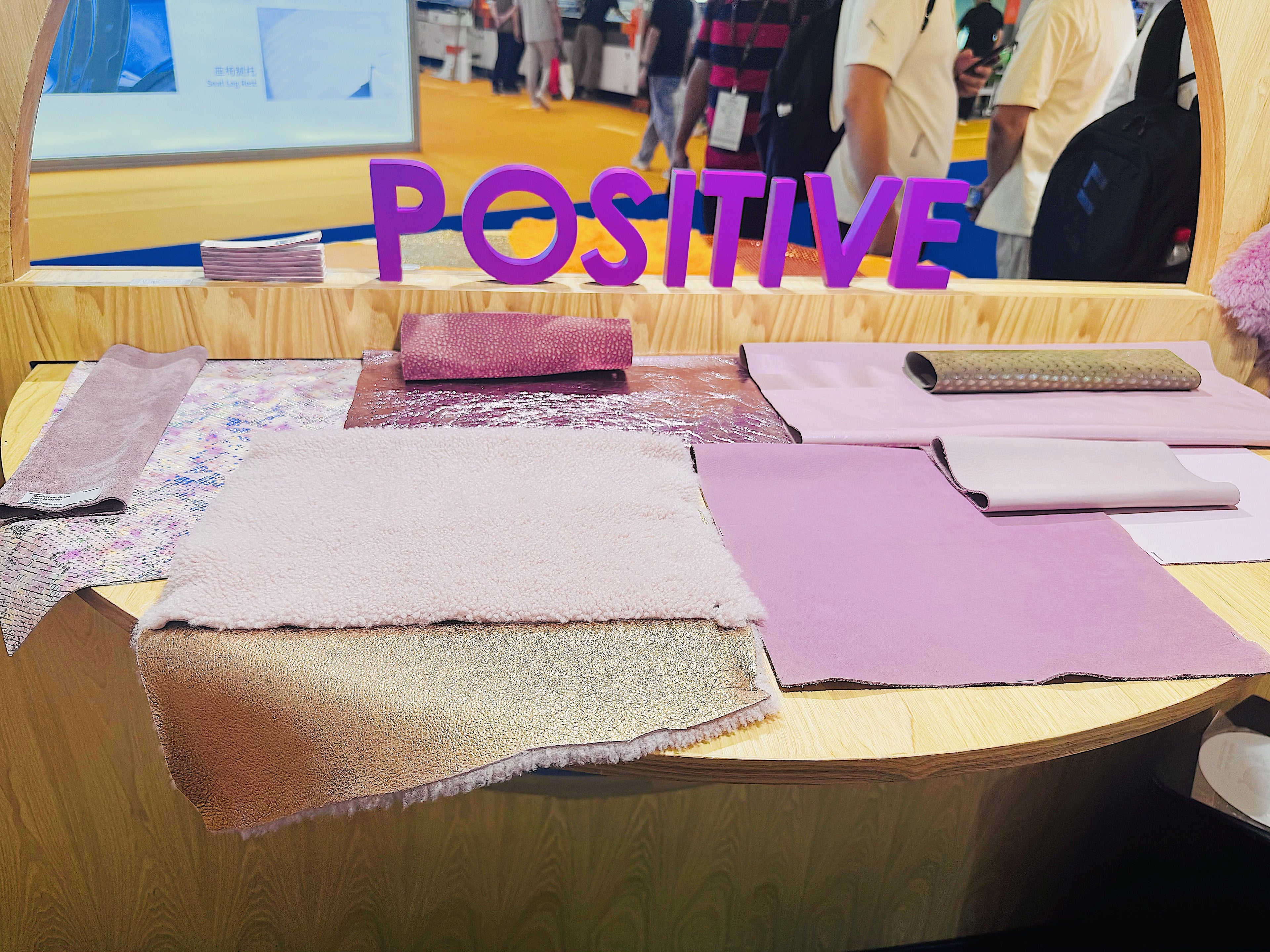 Handmade leather products with Chinese aesthetics displayed on a table featuring various textures and colors.