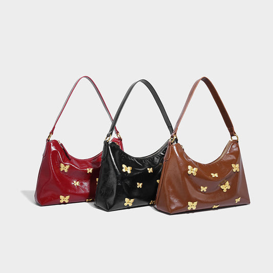Three vintage tote bags in red, black, and brown with butterfly embellishments.