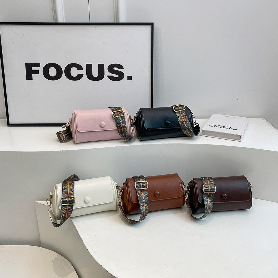 Collection of designer shoulder bags in various colors on display with focus on style and design.