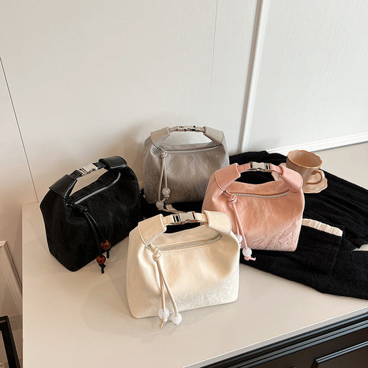 Collection of stylish designer hobo bags in various colors on a table.