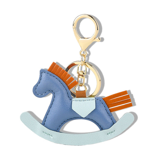 Handmade leather goods keychain in the shape of a rocking horse with colorful details.