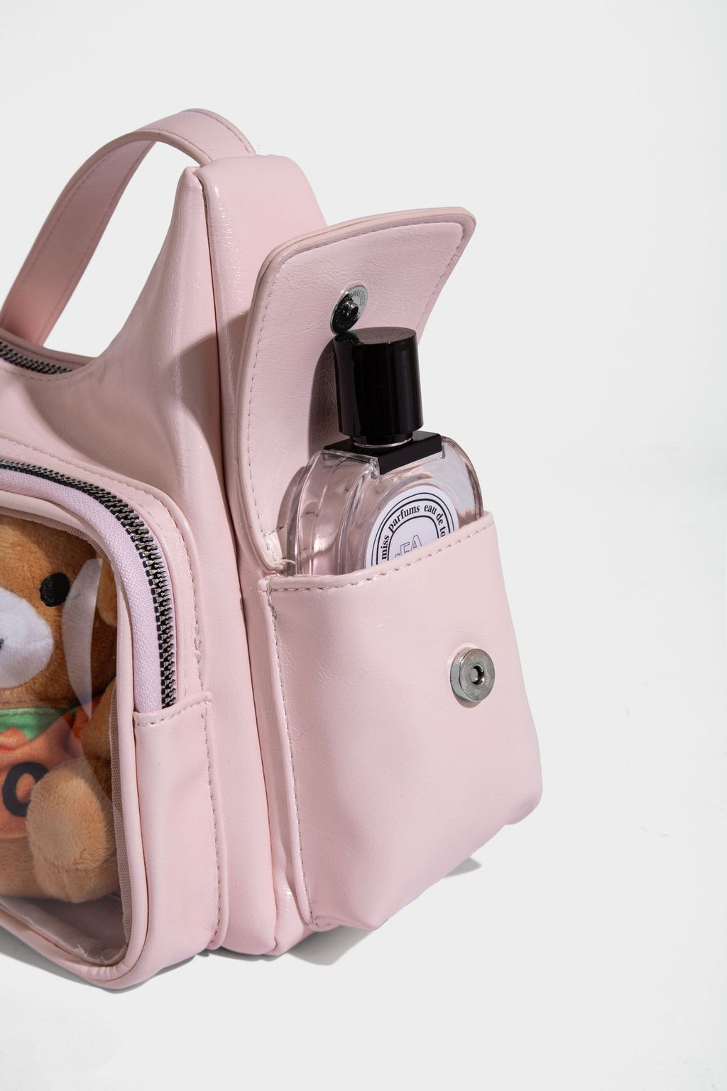 anime-inspired tote bag featuring a pocket with perfume and plush toy detail, stylish and practical accessory.