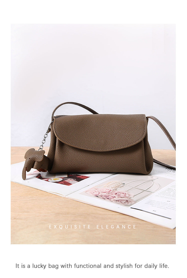 Mini Soft Cowhide Leather Bag on a table, showcasing its stylish and functional design.
