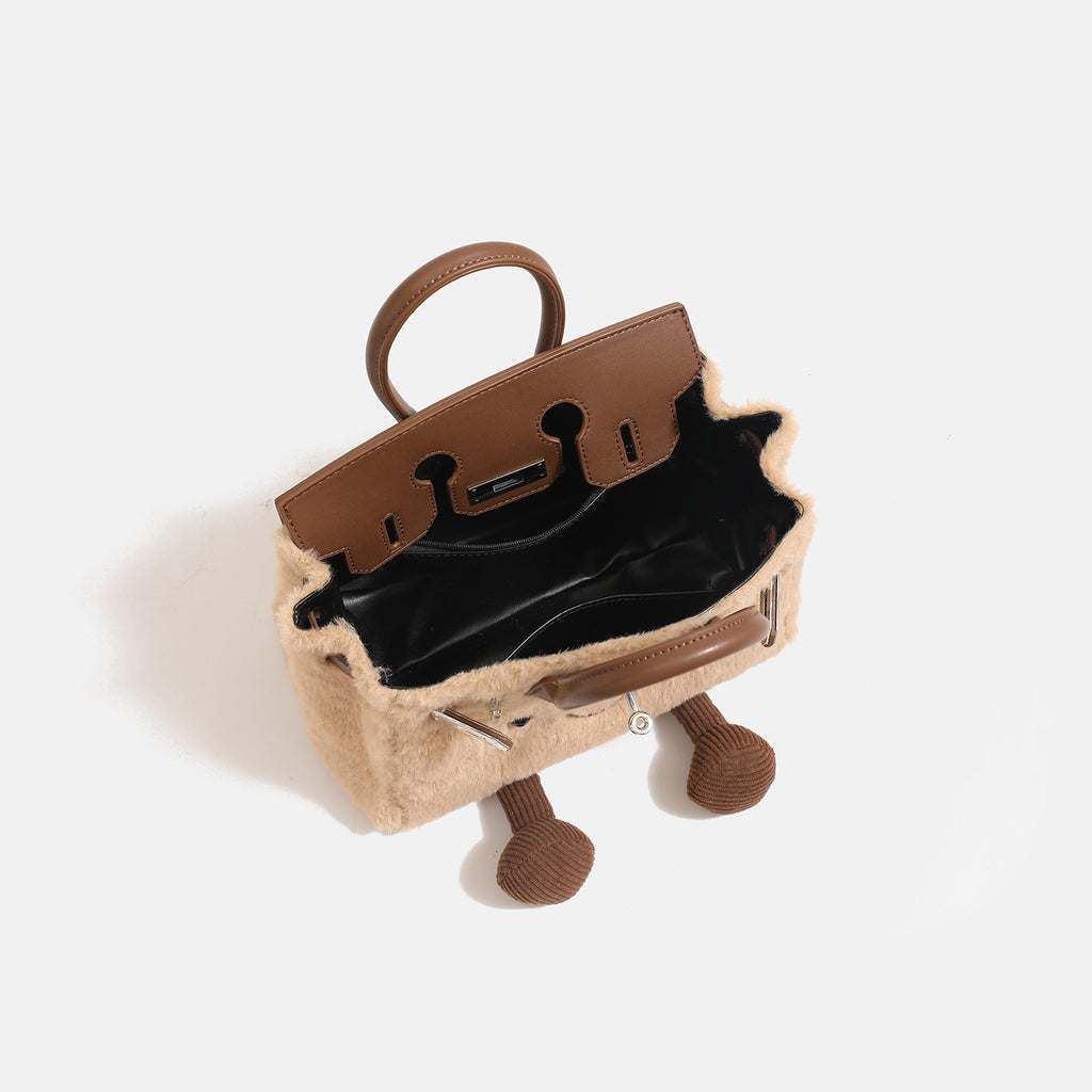 Woolen handbag for winter with brown handles and spacious interior, perfect for carrying essentials.