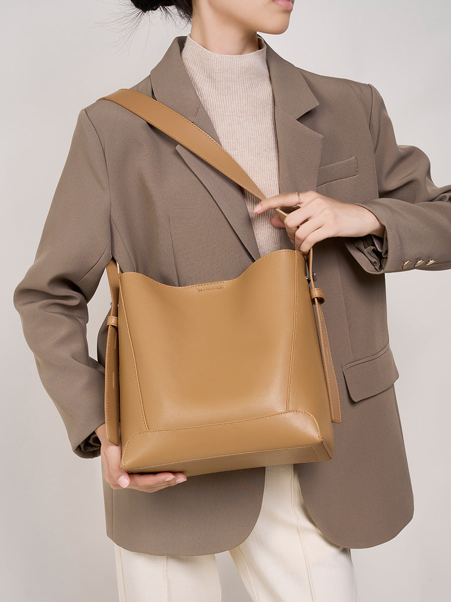 2026 genuine leather bucket bag showcased with a model in a stylish outfit, highlighting its premium quality and design.