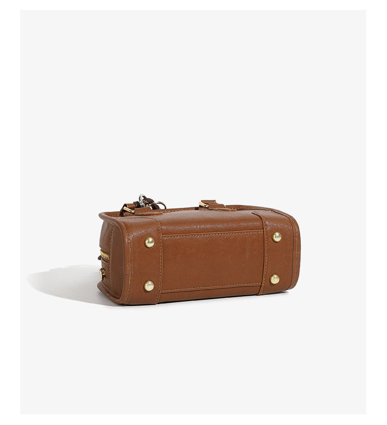 Classic leather Boston bag showing the bottom view with gold accents and supple leather texture.
