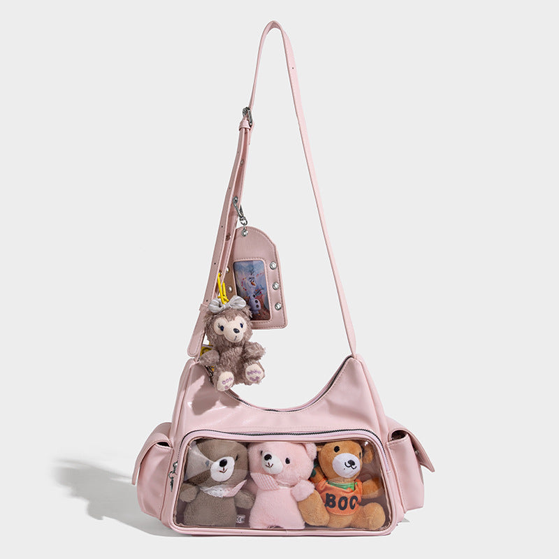 anime-inspired tote bag featuring cute plush toys in clear front pocket and stylish pink design.