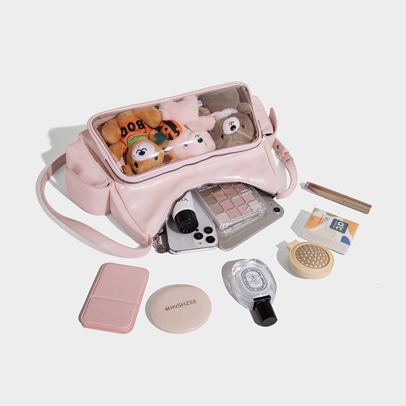 Anime-inspired tote bag containing plush toys, makeup, and essentials on a white background.