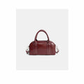 2026 leather Boston pillow bag in rich burgundy with dual handles and adjustable strap.