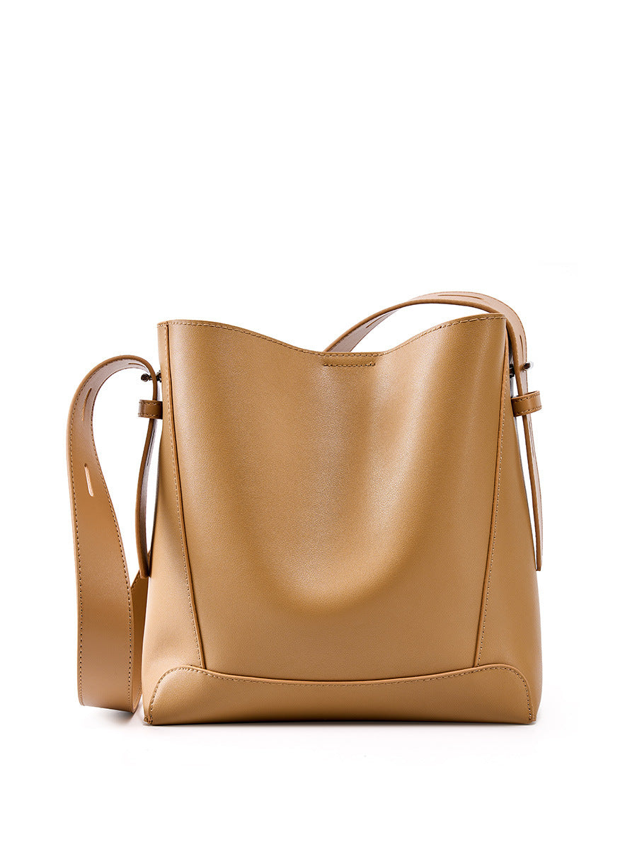 2026 genuine leather bucket bag in soft tan leather with adjustable strap and polished finish.