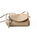 Mini Soft Cowhide Leather Bag with elephant charm and adjustable strap in beige color.
