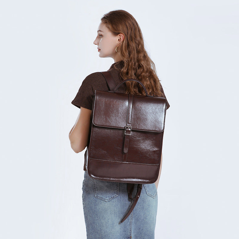 2025 Old School Classic Leather Ultra-Large Capacity Backpack worn by a woman with curly hair.