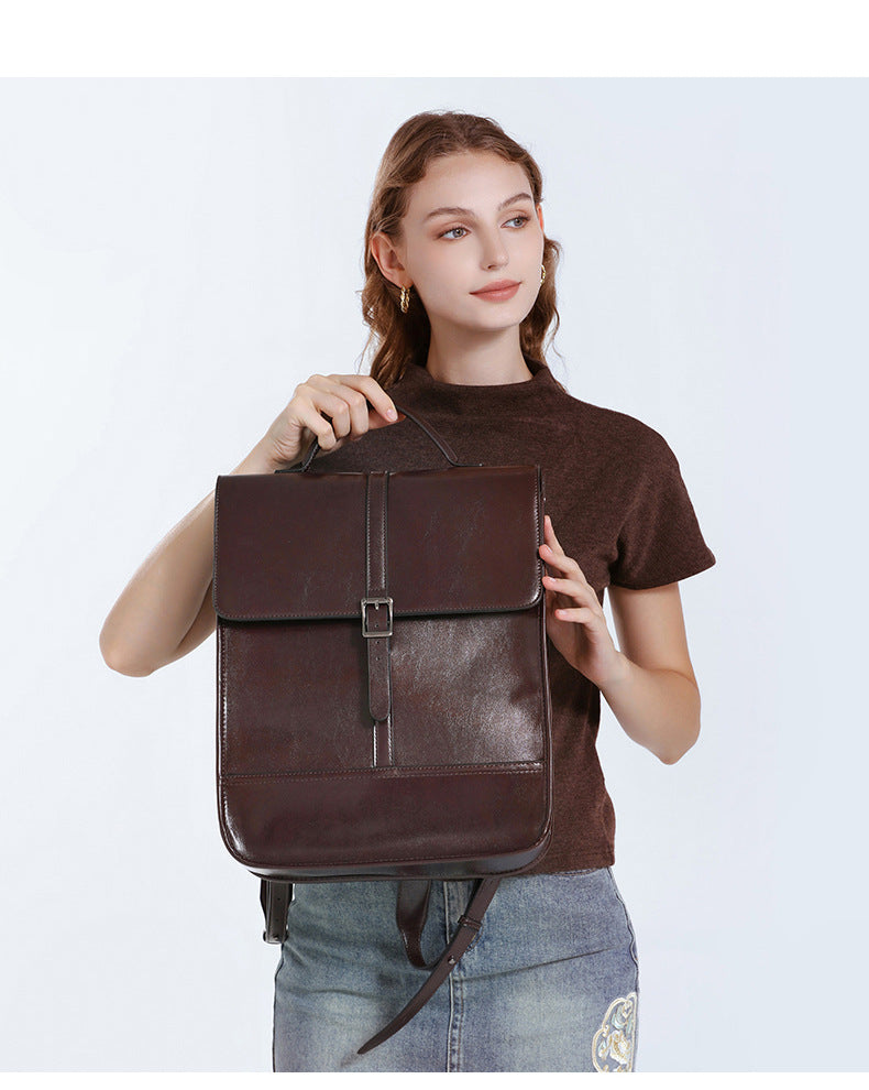 2025 Old School Classic Leather Ultra-Large Capacity Backpack being held by a model, showcasing its stylish design.