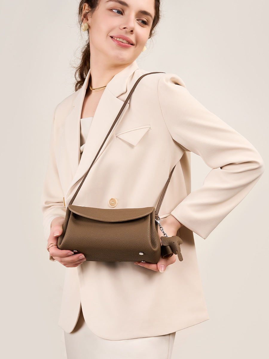 Mini Soft Cowhide Leather Bag stylishly worn by a model in a beige blazer, showcasing its compact design.