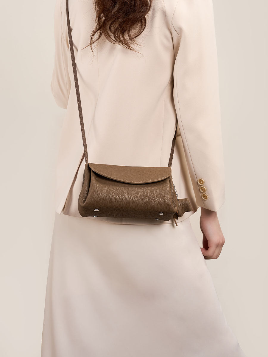 Woman wearing a Mini Soft Cowhide Leather Bag with a stylish outfit, highlighting its elegant design and versatility.