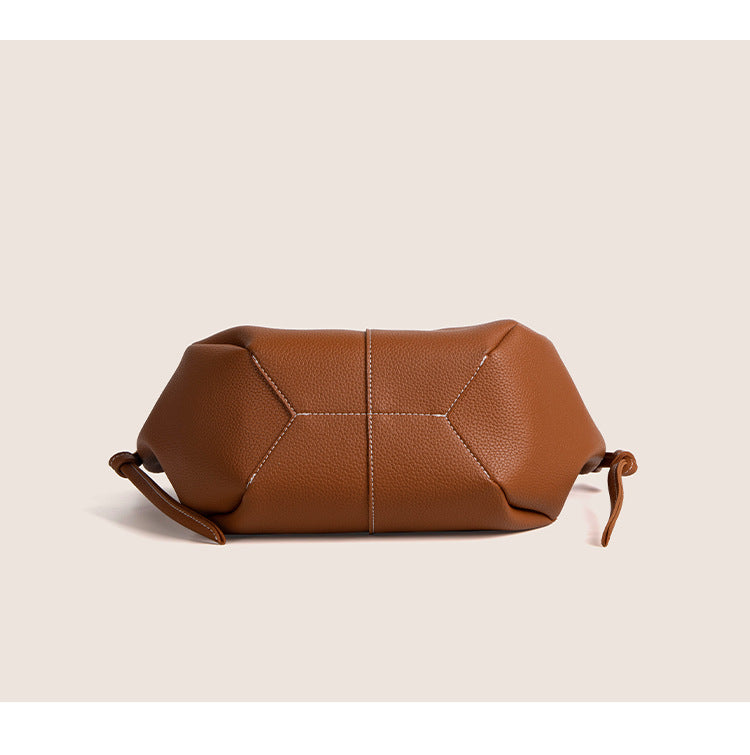 2025 winter vintage tote bag in brown leather, showcasing its unique shape and texture, perfect for stylish commuting.