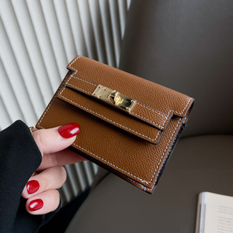 Elegant leather card bag in hand, showcasing premium brown leather and refined hardware for a stylish accessory.